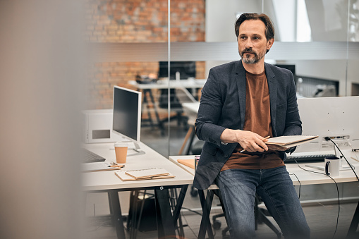 creative worker portrait in loft office surrounding.