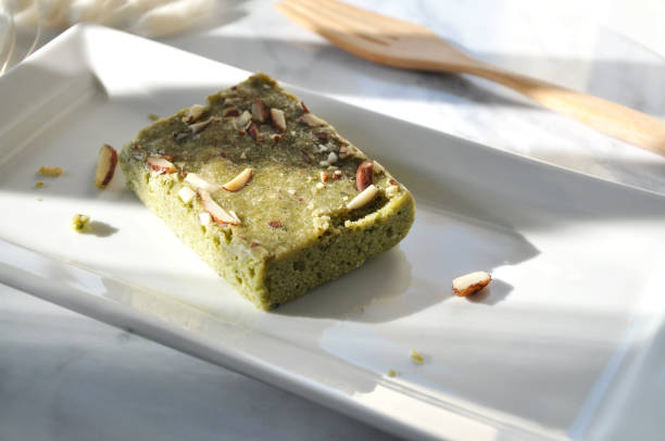 istock Window Light on Matcha Green Tea Brownie on White Plate Background 1253580497