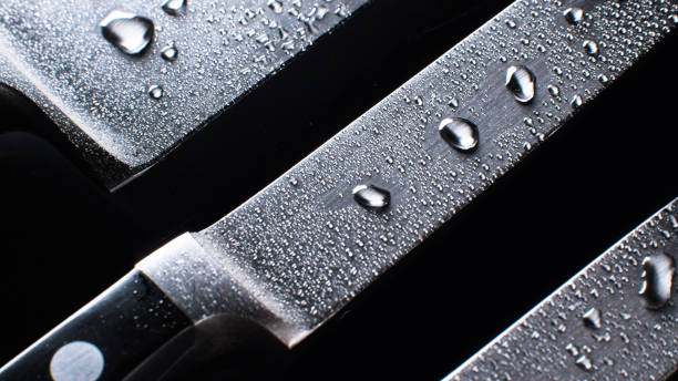istock Three professional chef knives in water drops 1253584516