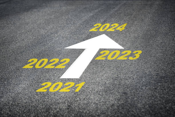 istock Year 2021 to 2024 and white arrow marking on road surface 1253585160