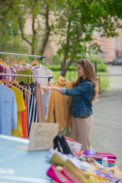 istock Nice pretty woman looking through different clothes 1253585282