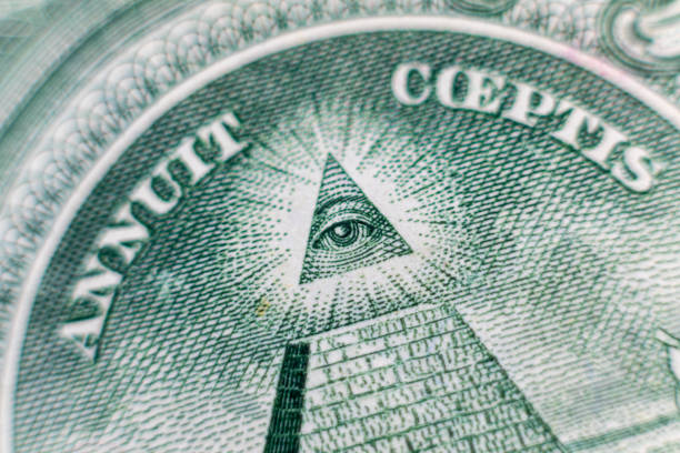 istock All-seeing eye on US one dollar bill closeup macro with soft focus on a pyramid. 1253586896