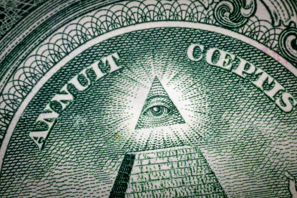 istock All-seeing eye on US one dollar bill closeup macro with soft focus on a pyramid. 1253586922