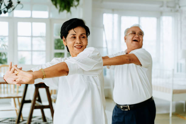 istock Happy ethnic senior couple dancing at home 1253586986