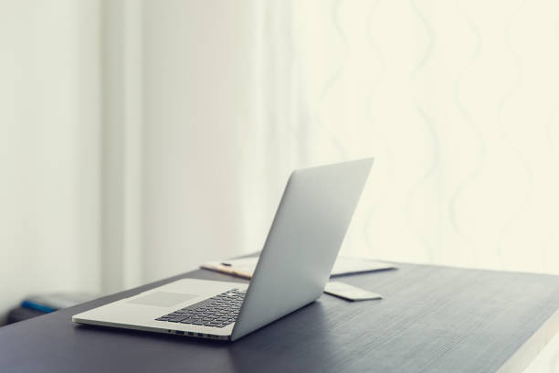 istock Laptop computer on a wooden desk, top view copy space 1253587882
