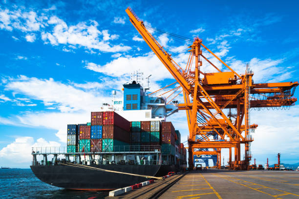 istock Large container ship discharging and loading container cargo at port terminal. Shipping industry. Logistics and supply chains. 1253588146
