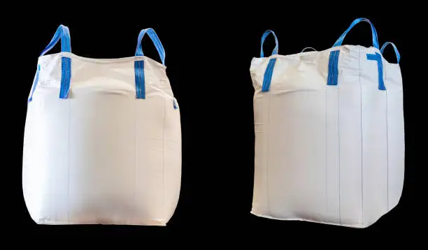 Jumbo bag of white sugar isolated on black background with clipping path.