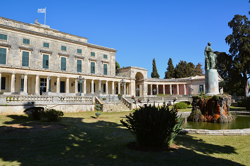 Corfu, Greece - March 4, 2017: Museum of Asian art in Kerkyra, Corfu island, Greece housed in The Palace of St. Michael and St. George. The statue of Sir Frederick Adam in front.