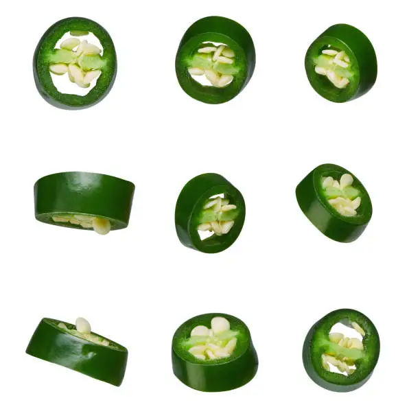 Photo of green chilli sliced different angles isolated on white background
