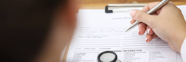 istock Person fills in a pen with document personal data 1253589916