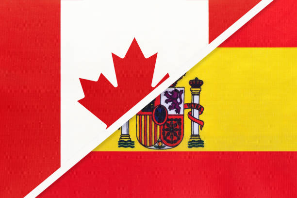 istock Canada and Spain, symbol of national flags from textile. Championship between two countries. 1253592038