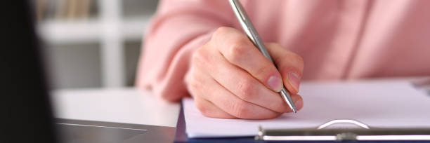 istock Closeup, female hands taking notes with pen office 1253593409