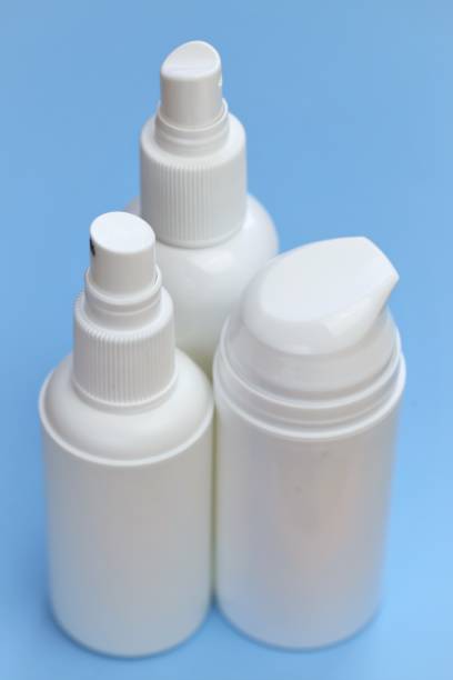 istock Plastic white bottles Mockup. Cosmetic bottles set on a light blue background. Beauty and health tools concept.Hand disinfector .Household chemicals and cosmetics white bottles. 1253594203