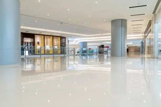 Photo of modern shopping mall interior with shopfront and corridor.