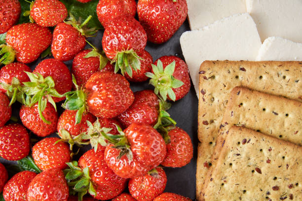 istock Sandwiches with fresh berries on a dark background, top view 1253596081