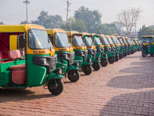 istock Yellow and green auto rickshaws in Indiya 1253596793
