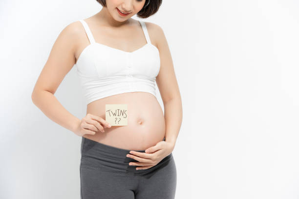 istock Pregnant woman with stick notes on her belly, 1253598975