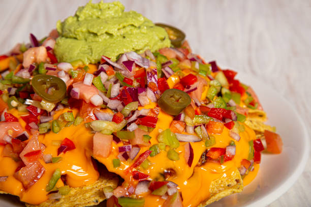 istock Homemade nachos with vegetable salad hash and guacamole. Closed image 1253599314