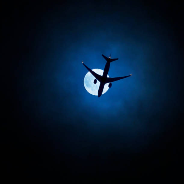 A plane soars past the crescent moon in a clear blue sky in Sydney, NSW, Australia. (Photo by Tara Chand Malhotra)