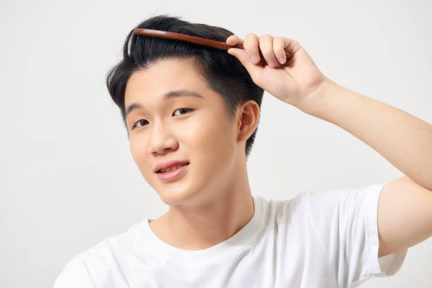istock Handsome smiling young man doing modern hairstyle 1253601177
