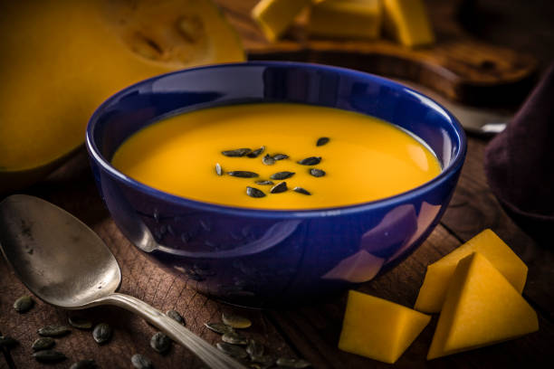 istock Pumpkin soup on a rustic wooden table 1253605220