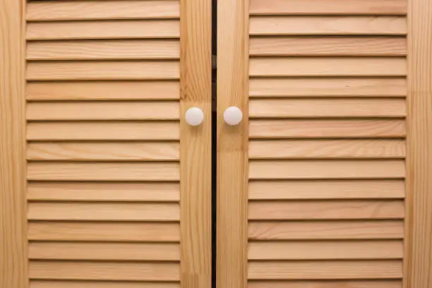 Wooden blinds doors. Striped timber material. Vintage home design.