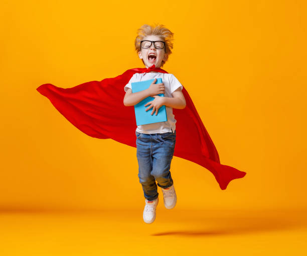 istock Excited little superhero jumping and screaming during studies 1253605858