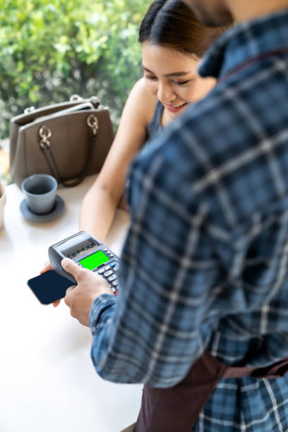 istock Asian customer make payment with contactless mobile phone. 1253606482