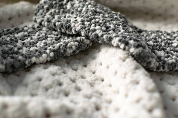 istock Fine textured and voluminous fabric in white and gray. Embossed textile pattern, pleasant to the touch and delicate, 1253606528