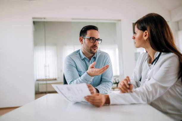 istock Patient and doctor talking on medical exam. 1253607506