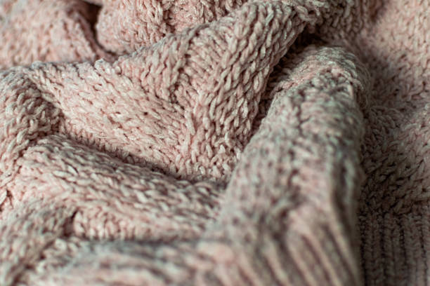 istock Fine textured and voluminous fabric in pink. Embossed textile pattern, pleasant to the touch and delicate, velvety 1253607813