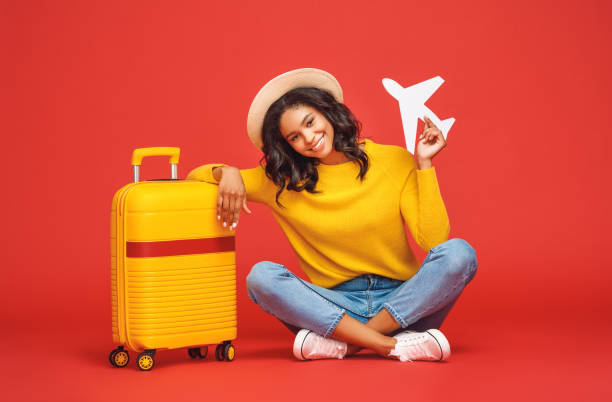 istock Positive ethnic tourist with toy plane 1253609089