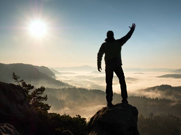 istock Man Silhouette Stay On Sharp Rock Peak. Satisfy Hiker Enjoy View. Tall Man On Rock Stone 1253609355