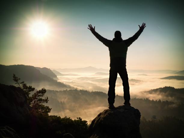 istock Man Silhouette Climbing High On Cliff. Hiker Climbed Up To Peak Enjoy View. 1253610142