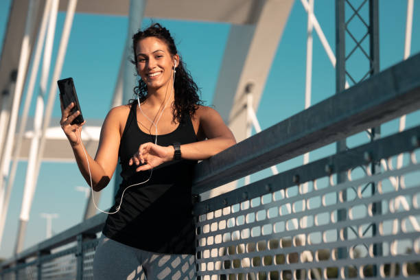 istock Fitness woman using smart phone 1253610307