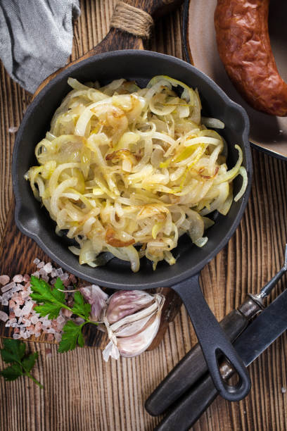 istock Fried onion in a cast iron skillet. 1253610553