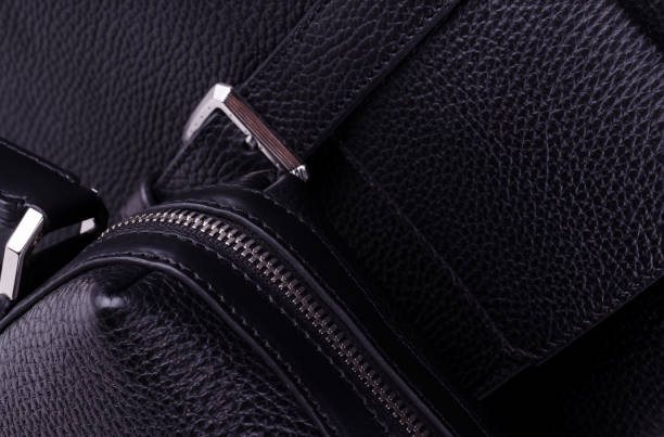 istock Silver metal clasp on a black leather belt against Genuine leather texture. 1253612974