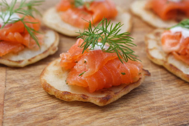 istock Pancakes with salted salmon on a wooden Board 1253614197
