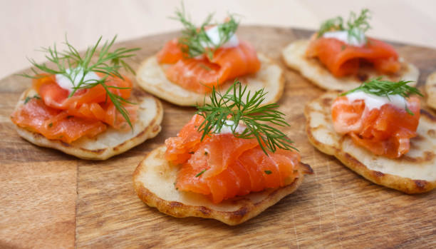 istock Pancakes with salted salmon on a wooden Board 1253614280