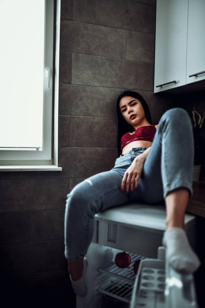 istock Asian Female Beauty Sitting On Fridge 1253614481