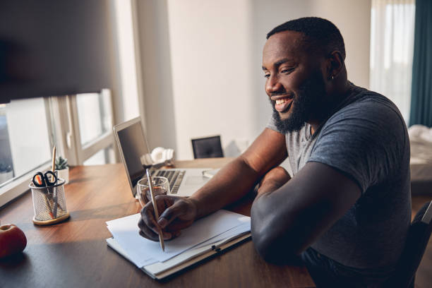 istock Positive delighted international man studying with great pleasure 1253616500