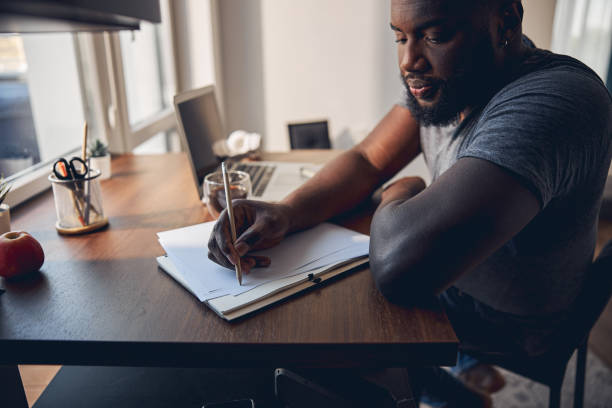 istock Concentrated young male person preparing for project presentation 1253616508