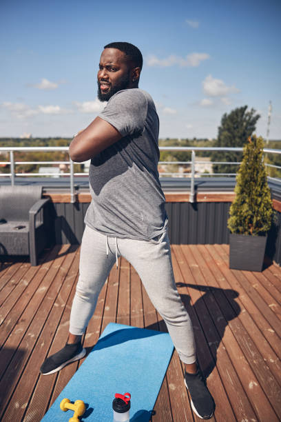 istock Concentrated brunette man doing sport on terrace 1253616637
