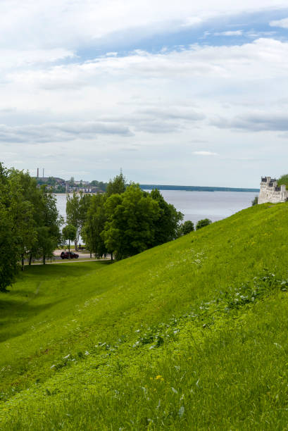 istock Green hills overlooking the river in the summer. 1253617752