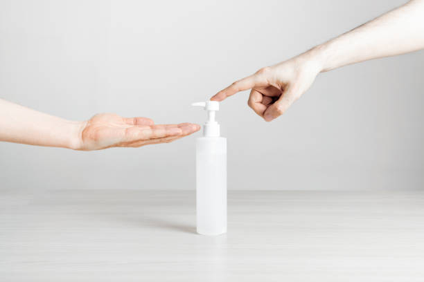istock Hand action using disinfectant gel spray on a white background table 1253618677