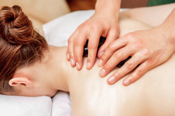 istock Stone massage on back of woman. 1253620127