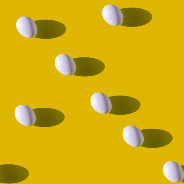 istock Creative wallpaper in the form of a repeating white egg on a yellow background. Seamless texture. 1253621291