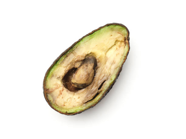 Avocado isolated on white background. Top view Rotten overripe halved avocado isolated on white background. Top view avocado brown stock pictures, royalty-free photos & images