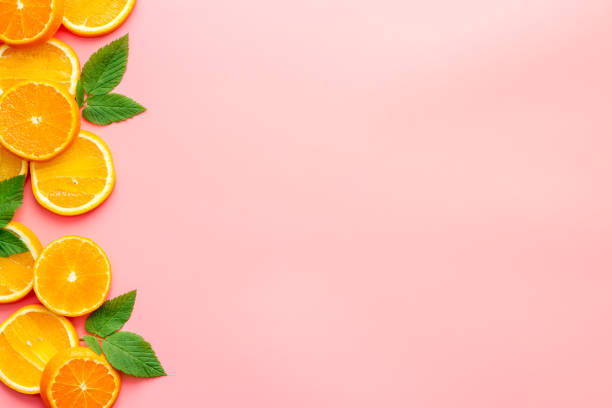 istock Orange slices with leaves top view, copy space 1253622991