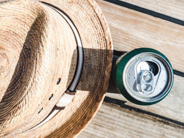 Can of beer on the background of a beautiful, wooden surface. Directly above, close-up. Concept of leisure and travel